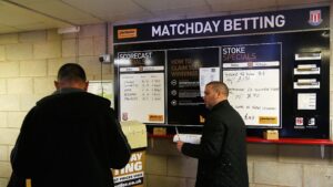 Apostas em esportes: Torcedores fazendo apostas na Premier League