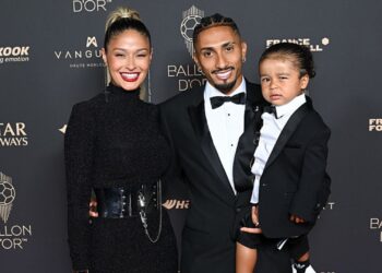 Raphinha ao lado de esposa e filho