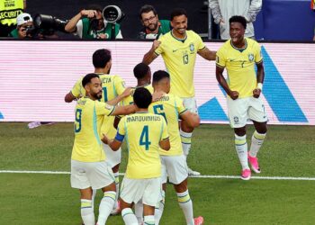 Jogadores do Brasil comemorando gol de Vini Jr